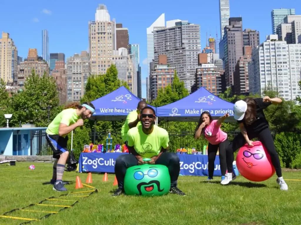 people racing on bouncing balls in a field day event