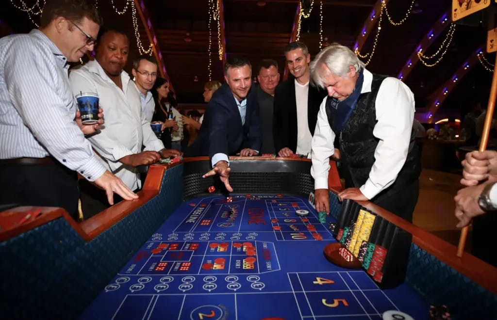 a group of people smiling and playing a table game