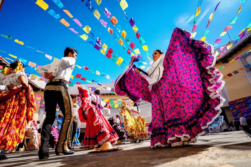 people dressed in colorful traditional hispanic clothing dancing