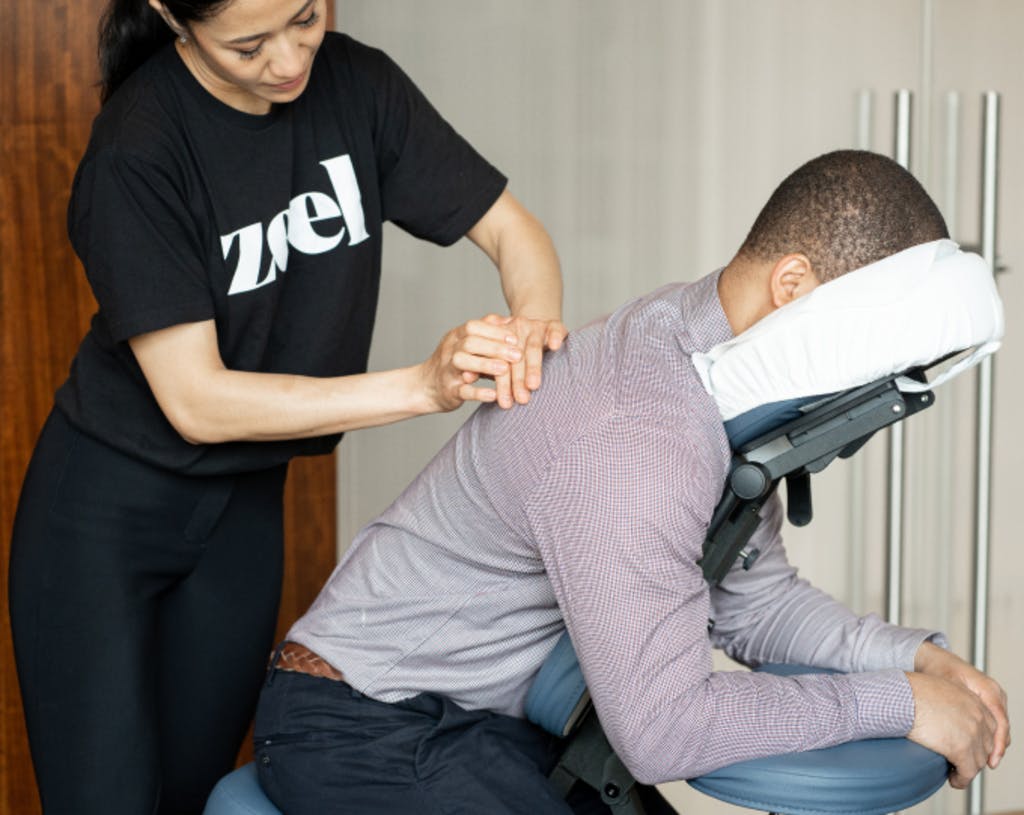 a man in a chair getting a massage