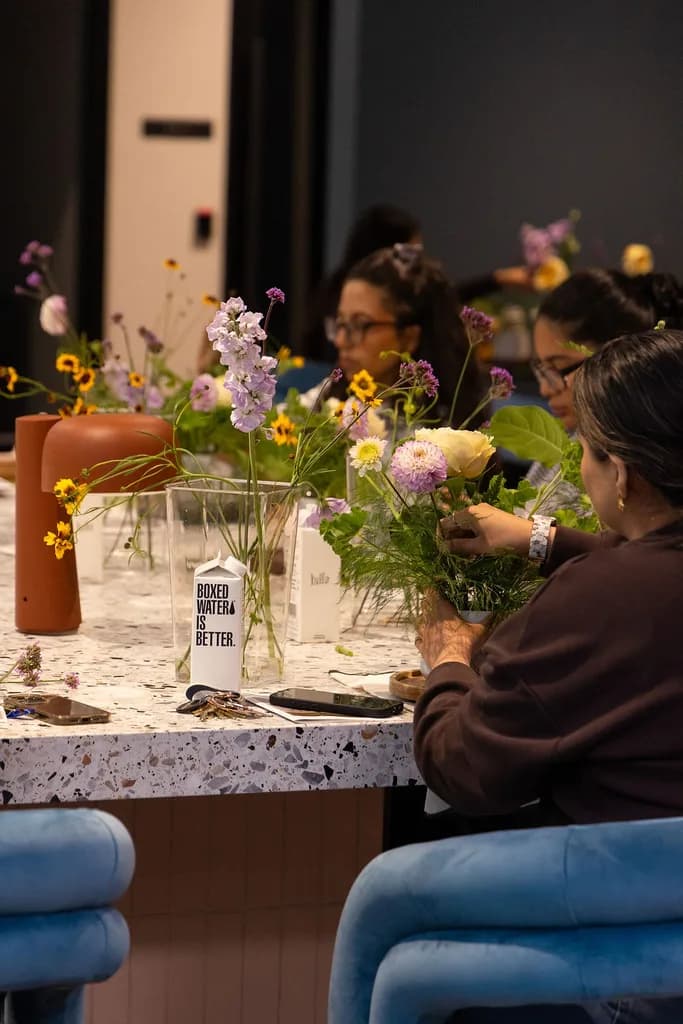 Photo by @Muccitas Guests arranging flowers at a floral workshop