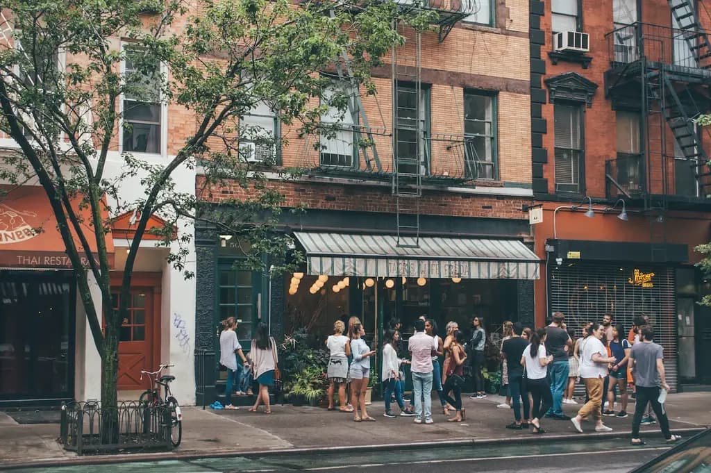 people gathered outside a shop