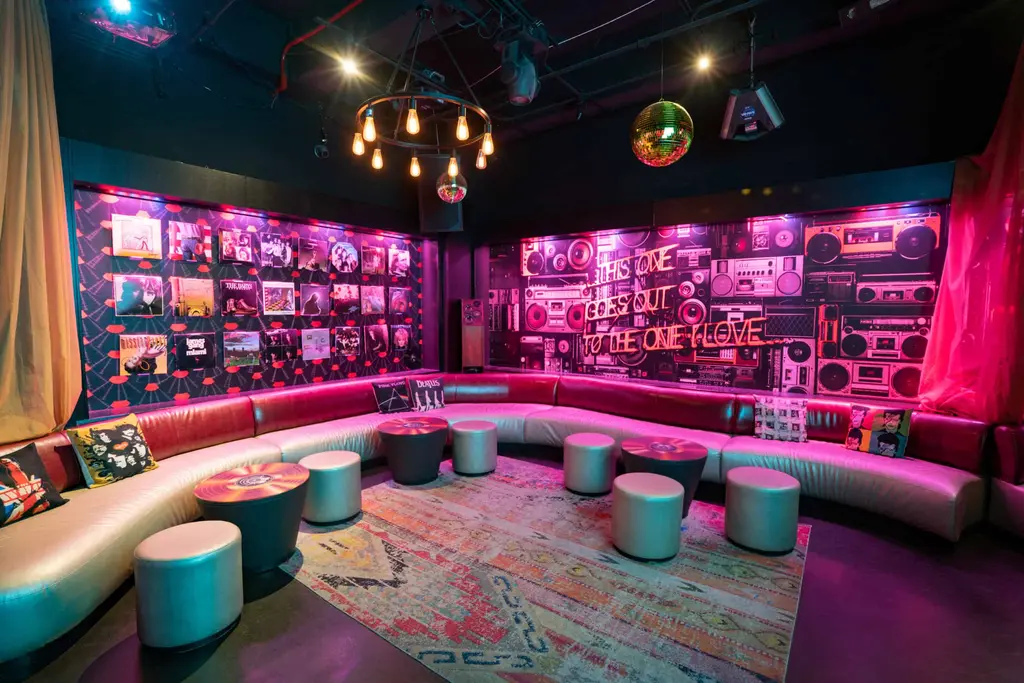 an open karaoke room with seating around the outsize