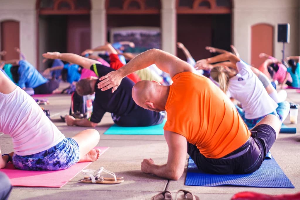 a group of people on yoga matts stretching