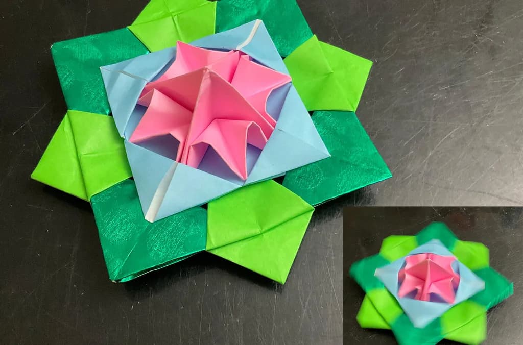 a close up of a multi colored origami flower
