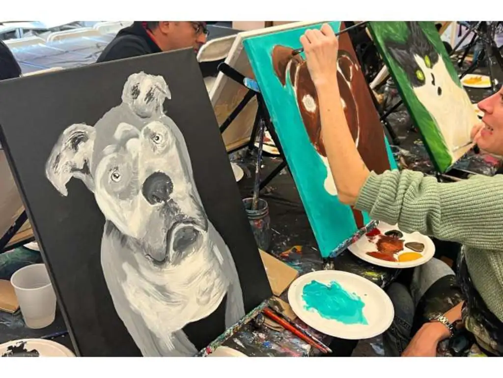 a row of people painting their pets