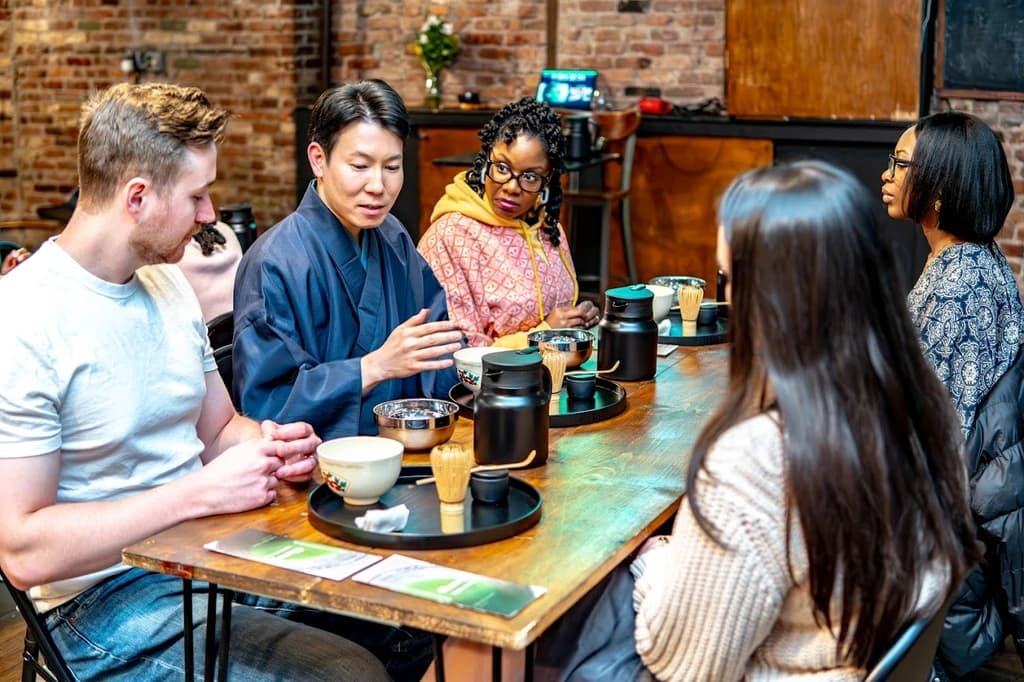 people sitting around a table trying different teas